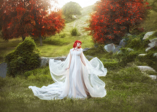 A young, red-haired elf waving a raincoat against the backdrop of autumn hills and a path that leaves at a distance. The wizard, like a bird, flaps her wings from the fabrics, in a white, flying dress