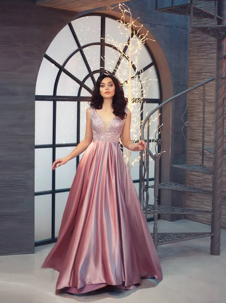 Tender gorgeous graceful lady at vintage stairs, girl in long gorgeous pink tender dress with sparkles, attractive beauty with dark brunette hair, nice image for prom, evening party, christmas — Stock Photo, Image