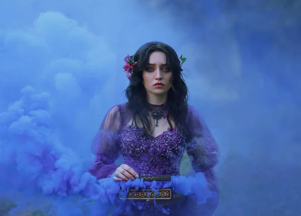 Casket Padora. Sad girl holds the evil gift of the gods - a box that is filled with evil. A woman cries that she could not contain her curiosity and released trouble. Background blue smoke. — Stock Photo, Image
