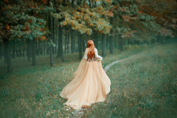 Mysterious lady in long light expensive luxury dress with long trailing train runs along forest path, new Cinderella tale, graceful princess runs away from ball, no face in photo with art processing.