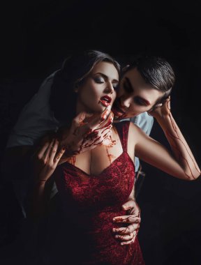 Vampir, kız ve adam karanlık odada kollar, göğüs ve yüz, şeytan, kırmızı elbise ve boynuna ısırma adam seksi Bayan ile oyunun korkunç hikayeler kırmızı kanlı kanlı tutkulu aşk hikayesi