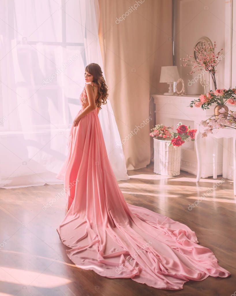 image of spring, sweet and gentle lady in long gorgeous pink dress looking directly at camera, , a girl like a rose flower, stands with her back to the camera near large window, nude colors