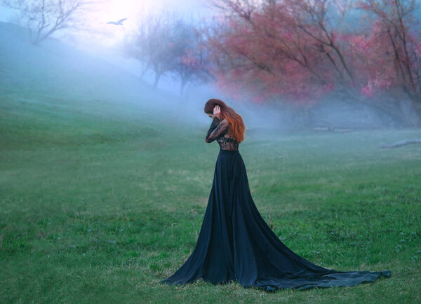 Dark witch made terrible mistake, sad lady in long black dress with long tail and lace sleeves, girl with bright red orange hair pressed hands to head, autumn landscape, mysterious white haze.