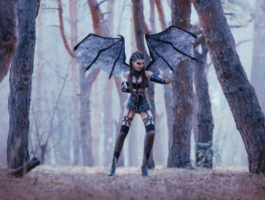 wild bat protects forest from strangers, sexy passionate demoness in latex leather short skirt and stockings with dark makeup and creative hair, aggressive satan woman with long claws and wings clipart