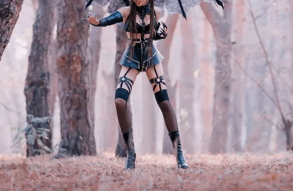 Dark mistress in sexy seductive costume in jump, aggressive demoness in short leather latex skirt and belts, copronic stockings on succubus with long remaining claws, mythical creature without face — Stock Photo, Image