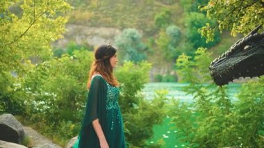 Fantezi kadın kraliçe evcil ejderhaya annesi gibi sevgiyle dokunur. Sihirli yaz ağaçları yeşil nehirden ayrılıyor. Elf elbisesi. Prenses tanrıça seksi kız model ve efsanevi hayvan. video 4k