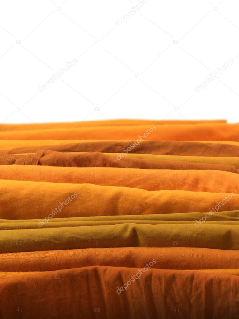 The Yellow robe in many Earth tones for the monk. The yellow fabric of a Buddhist Monk or A Buddhist Novice. Texture and Background Concept.