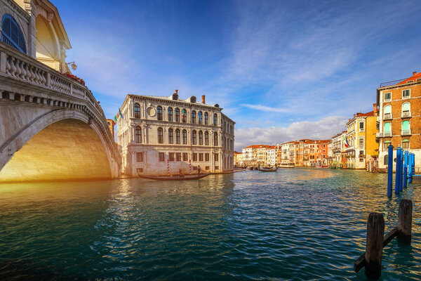 Rialto bridge in Venice, Italy. Venice Grand Canal. Architecture and landmarks of Venice. Venice postcard with Venice gondolas