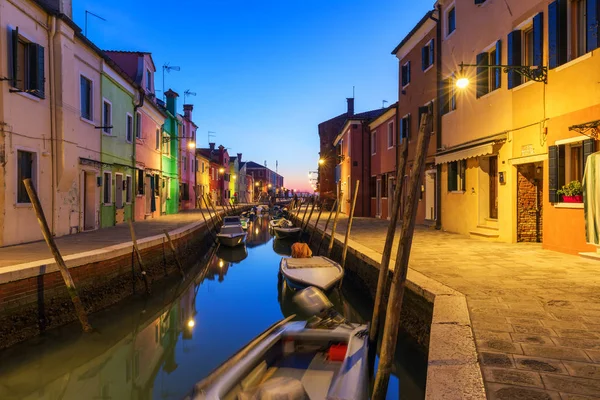 Colorful houses at night in Burano, Venice Italy. Night lights on the beautiful Burano island. Venice, Italy. Colourfully painted houses facade on Burano island in evening, province of Venice, Italy