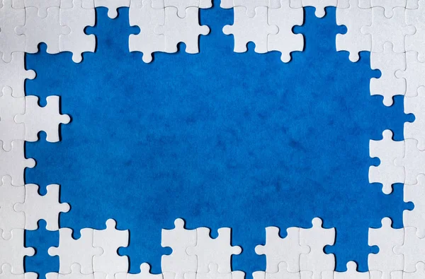 Framing in the form of a rectangle, made of a white jigsaw puzzl — Stock Photo, Image