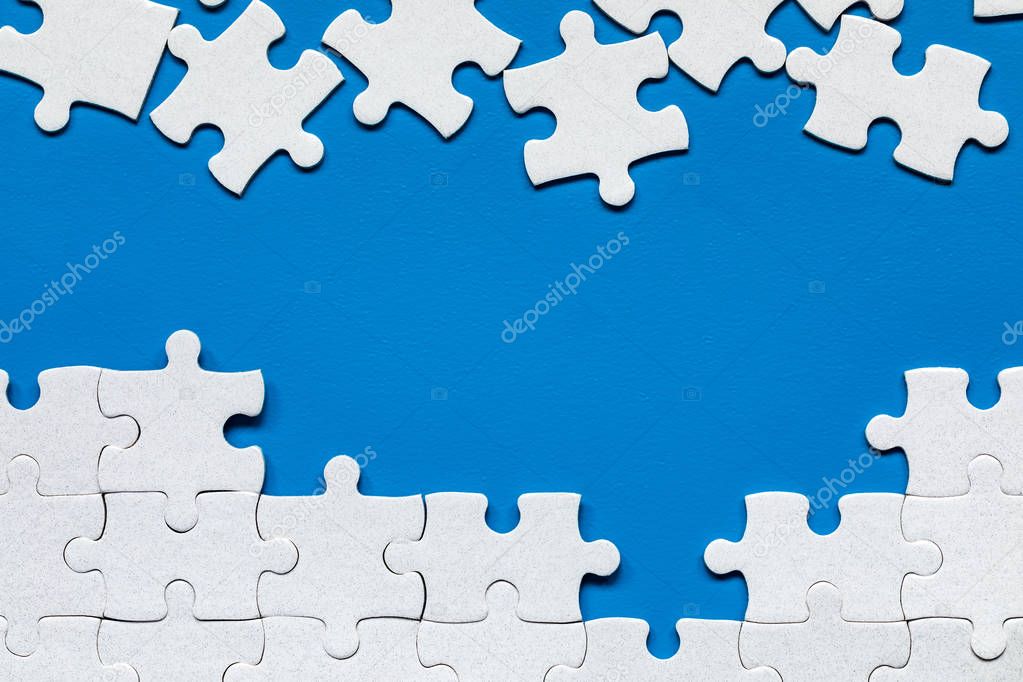 White jigsaw puzzle. White puzzle pieces on color background. Un