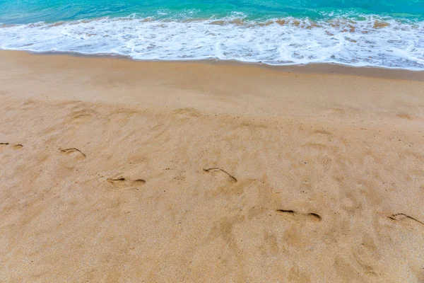 Footsteps in the sand. Footprints in the sand beach. Footprints