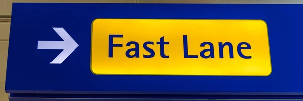 Fast Lane sign in blue and yellow at the airport close up. Fast