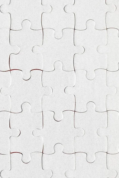 Unfinished white jigsaw puzzle pieces. Fill in pieces of the jig