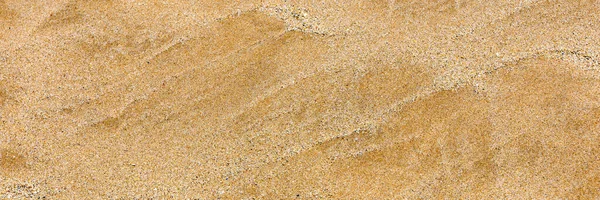 Sandoberfläche und Hintergrund. Sandstruktur. Brauner Sand. Hintergrundinformation — Stockfoto