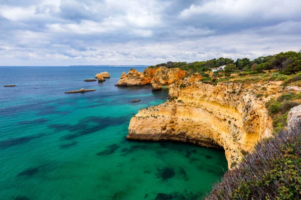 Vista de la impresionante playa con rocas de color dorado en la ciudad de Alvor, A — Foto de Stock