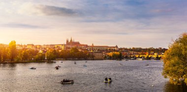 Çek Cumhuriyeti Prag 'daki Vltava nehri üzerindeki Charles Köprüsü' ne sonbahar manzarası. Sonbahar manzaralı Charles Köprüsü, Prag 'ın eski kasabası ve Vltava nehri. Çek malı. Kırmızı yapraklı Eski Şehir 'in sonbahar manzarası.