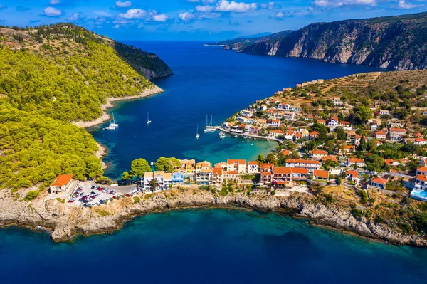 Aerial drone view video of beautiful and picturesque colorful traditional fishing village of Assos in island of Cefalonia, Ionian, Greece. Peninsula of Assos in Cephalonia (Kefalonia), Greece