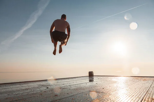 Tipo Está Saltar Cais Céu Sol Verão Homem Fuga — Fotografia de Stock