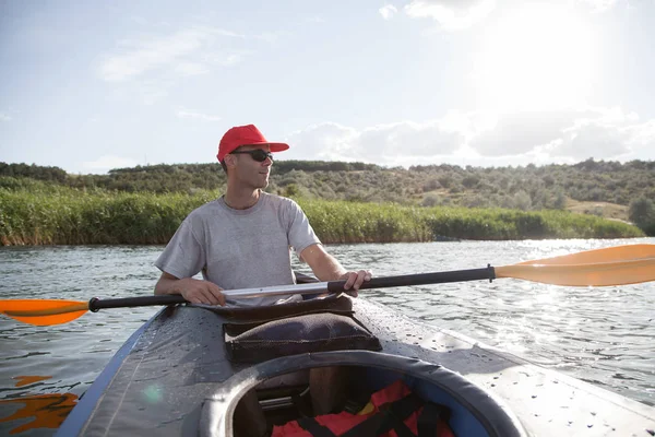 A young man on a kayak. Water sports.