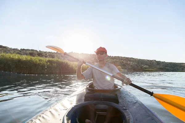 A young man on a kayak. Water sports.