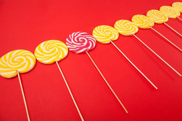 Bright candy on a red background. Lollipops. Handmade.