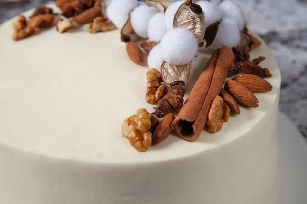 Decorated cake with nuts and spices close up.