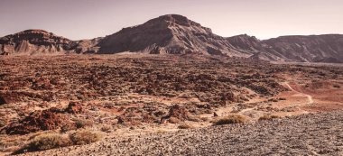 Volkanik dağlar ve pembe gökyüzü manzaralı güzel manzara.