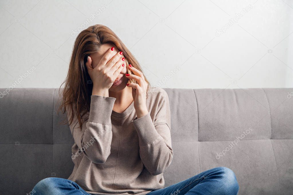 Young woman and mobile phone in a room.