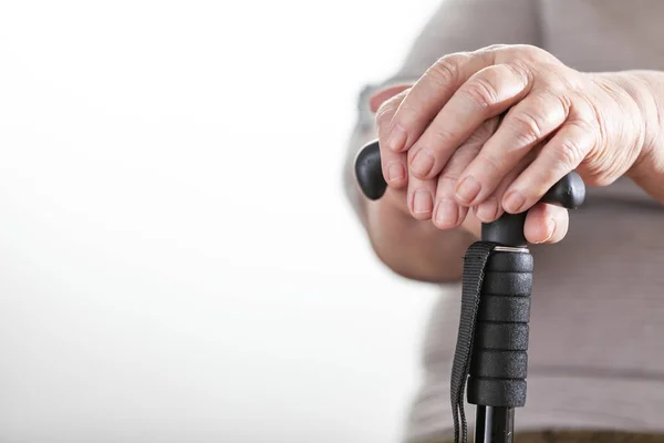 Female elderly hands hold a care wand. Retired woman.