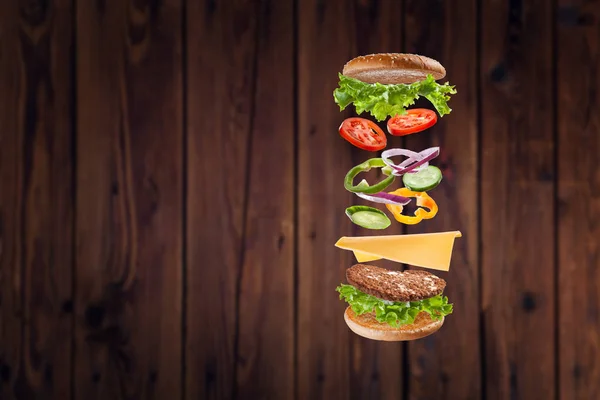 Delicioso Hambúrguer Com Ingredientes Voadores Cozinhar Fast Food — Fotografia de Stock