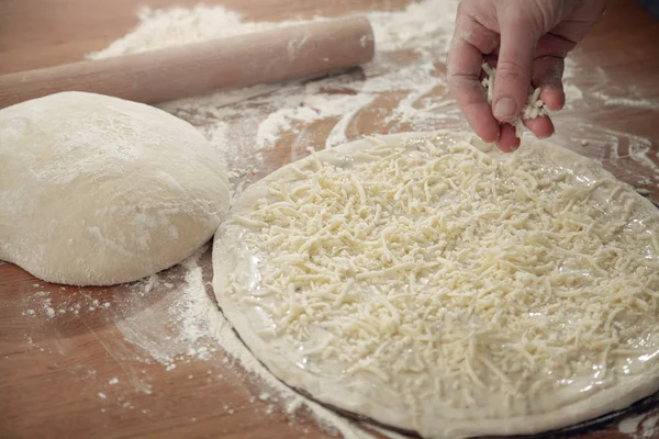 A man is cooking pizza. The cooking process.