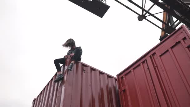 La ragazza siede su un container — Video Stock