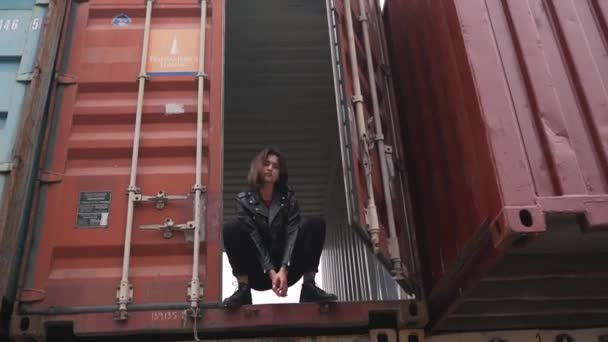 Girl in denim sitting in the container — Stock Video