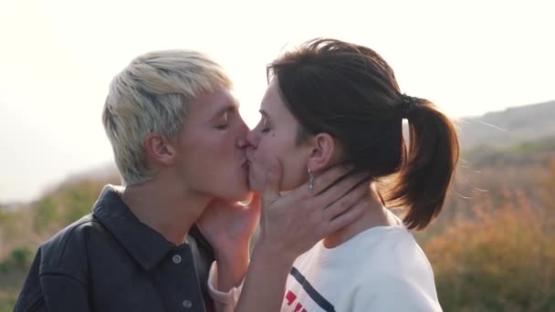 Passionate kiss of a young couple outdoor — Stock Video