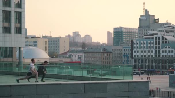 Los hombres se calientan antes de correr en la ciudad — Vídeo de stock