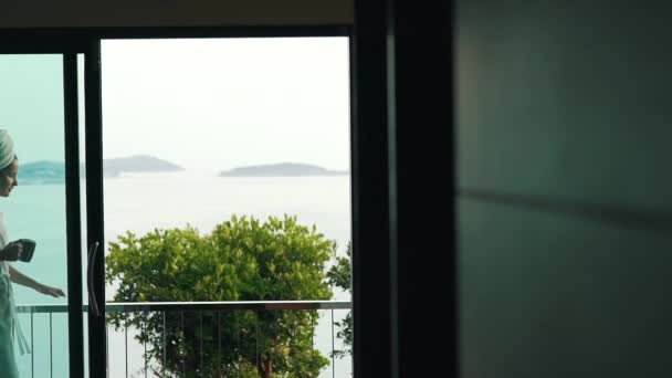 Girl drinking coffee on the balcony on vacation — Stock Video