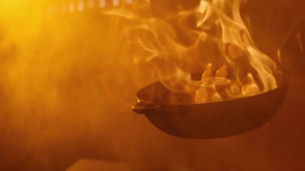 Chef cooking in a pan with fire close-up — Stock Video