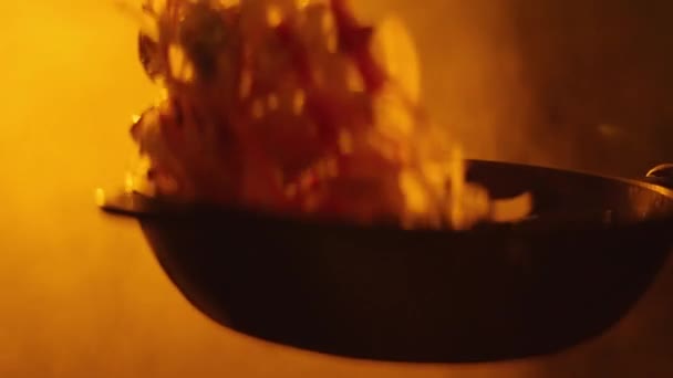 Cooking wok on a fiery frying pan close-up — Stock Video