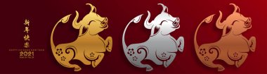 2021 yılında Çin 'de öküz, kırmızı kağıt arka planda el işi tarzıyla öküz, çiçek ve Asyalı elementleri kesiyor. (Çince çevirisi: Mutlu Çince yeni yıl 2021, öküz yılı)