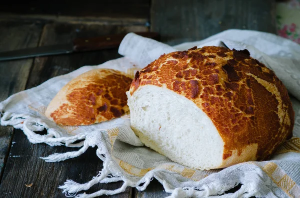 Tiger bread on a wooden table and linen tablecloths in a rustic style