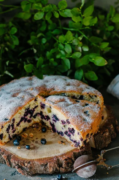 Cut cake with blueberries in a rustic style