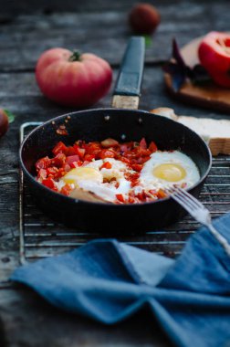 Shakshuka, Pan, rustik tarzı ve ahşap arka plan domates soslu kızarmış yumurta