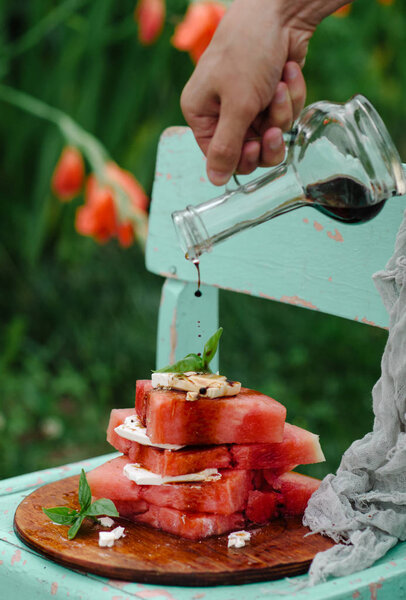 appetizer stacked slices of watermelon, feta, basil and balsamic.