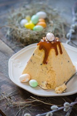 Traditional Easter cottage cheese dessert. Easter Ortodox curd cake with caramel and chocolate egg decor. Rustic style clipart