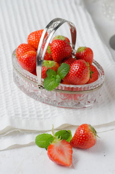 Heap of fresh strawberries in in a crystal basket on white background. Places for text. Postcard — Stock Photo, Image