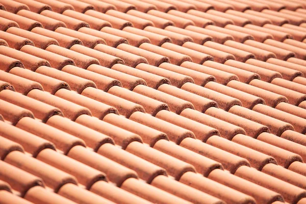 Closeup of orange red clay roof tile seamless pattern for house covering in red color
