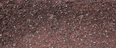 Çimentoyla karıştırılmış bir sürü küçük ya da küçük taşı kapat. Beton duvarın kırmızı yüzeyi, döşeme dokusu ve web tasarımı ve mimarı için arkaplan.