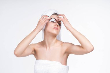 young girl sticks patch for eyes. Nude in a towel on the chest and head. European 20 years old