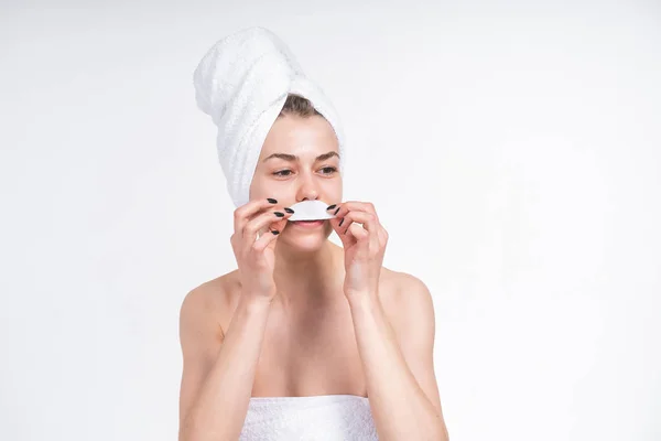 young girl sticks patch for eyes. Nude in a towel on the chest and head. European 20 years old